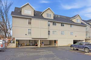 View of building exterior featuring uncovered parking