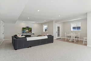 Living room with recessed lighting and light carpet
