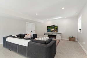 Living room featuring recessed lighting and light carpet
