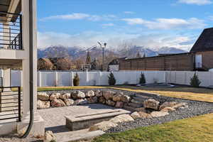 Fenced backyard with a mountain view and a patio
