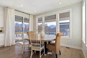 Dining space featuring a mountain view, light wood finished floors, plenty of natural light, and recessed lighting