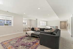Living room with light colored carpet and recessed lighting