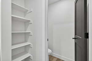Bathroom featuring wood finished floors and toilet