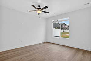 Unfurnished room with light wood finished floors and ceiling fan