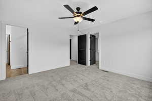 Unfurnished bedroom featuring carpet flooring and a ceiling fan