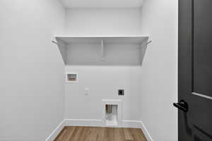Washroom featuring light wood-type flooring, electric dryer hookup, and hookup for a washing machine