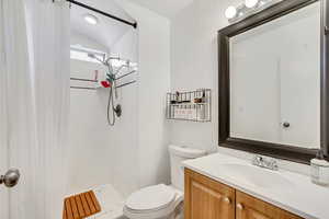 Full bathroom with a shower stall and vanity