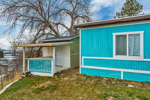 View of side of home with a yard