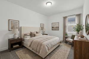 Carpeted bedroom featuring baseboards