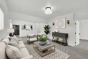 Living room featuring carpet flooring and a chandelier