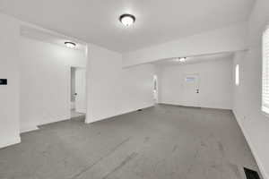 Carpeted empty room with baseboards