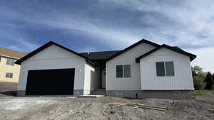 View of front facade with an attached garage and driveway
