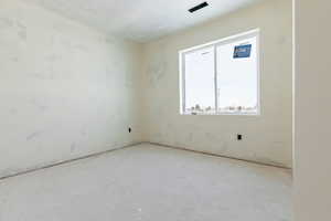Unfurnished room with a textured ceiling