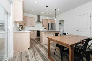Dining space with light wood-style flooring and recessed lighting