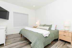 Bedroom with light wood finished floors and recessed lighting