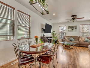 Dining area with light wood-type flooring, a ceiling fan, and recessed lighting