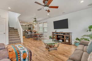 Living room featuring recessed lighting, stairway, light wood finished floors, and a ceiling fan