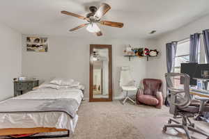Bedroom 2 featuring carpet floors, a ceiling fan, and a desk