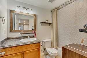 Downstairs Ensuite Full bathroom featuring vanity and shower / tub combo with curtain