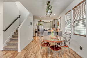 Dining area with stairway, light wood-style flooring, and recessed lighting