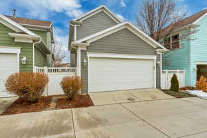View of front facade featuring a garage and driveway