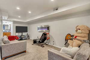 Downstairs Suite Living area with recessed lighting and carpet flooring
