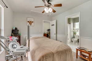 Bedroom 1 with a ceiling fan and ensuite bath