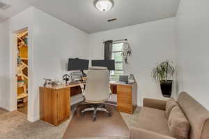 Office space with light carpet and baseboards