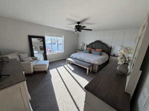 Bedroom featuring dark carpet and a ceiling fan