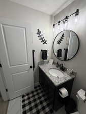 Bathroom with vanity and a textured ceiling
