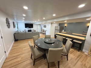 Dining area featuring light wood-style floors and recessed lighting