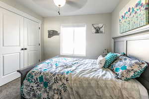 Bedroom with carpet flooring, a ceiling fan, and a closet