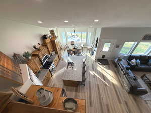 Living room featuring light wood finished floors and recessed lighting