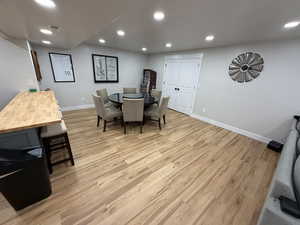 Dining space with recessed lighting and light wood-type flooring