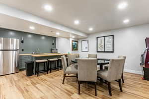 Dining space featuring light wood-type flooring and recessed lighting