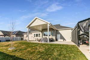 Rear view of property with stucco siding and a patio