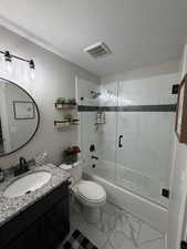 Full bathroom featuring shower / bath combination with glass door, a textured ceiling, vanity, and light marble finish flooring