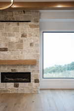 Detailed view of a fireplace and wood finished floors