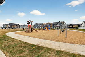 Community playground with a residential view and a yard