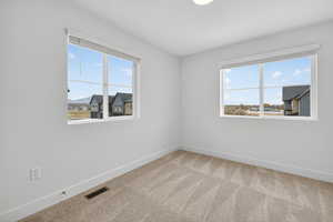 Empty room with carpet and plenty of natural light