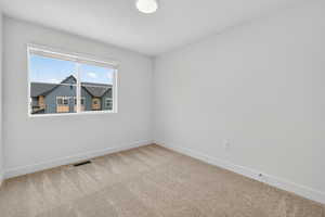 Empty room with baseboards and carpet