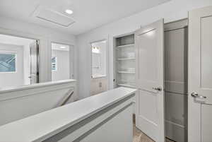 Corridor featuring recessed lighting and an upstairs landing