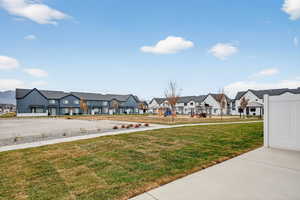 View of grassy yard featuring a playground and a residential view