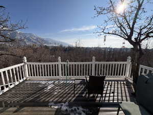 Wooden deck featuring a mountain view and grilling area