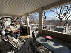 Deck with a mountain view and area for grilling