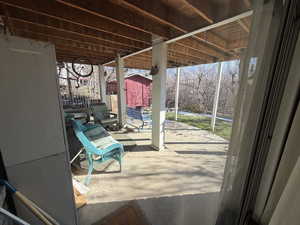 View of patio / terrace featuring a shed