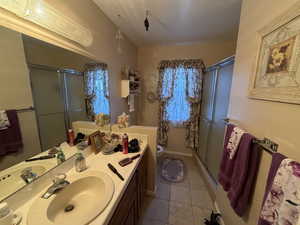 Bathroom with vanity and light tile patterned floors