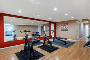 Exercise room featuring recessed lighting and light wood finished floors