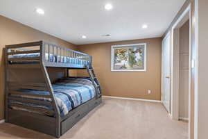 Bedroom featuring light carpet and recessed lighting