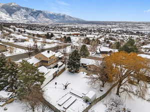 Snowy aerial view with a mountain view and a residential view